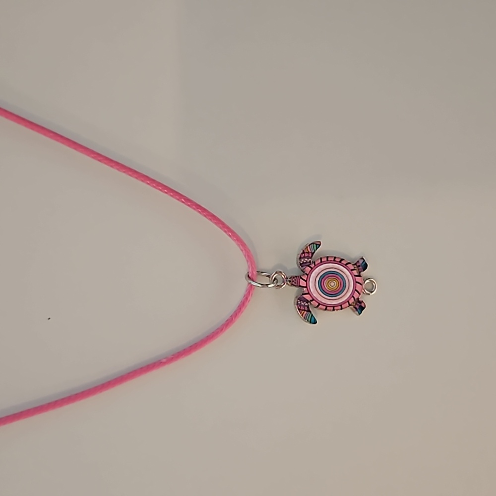 Turtle charm on corded necklace